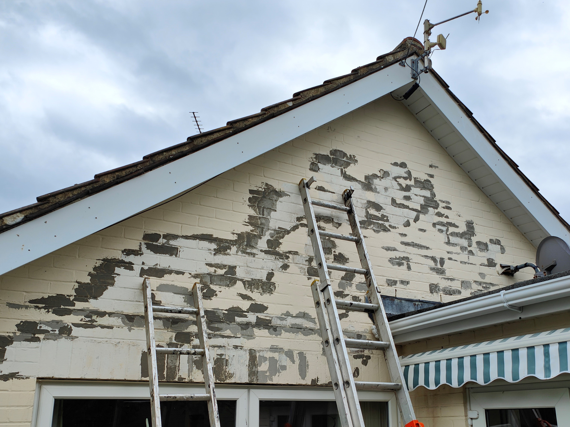 Peeling paint on an external wall of a house